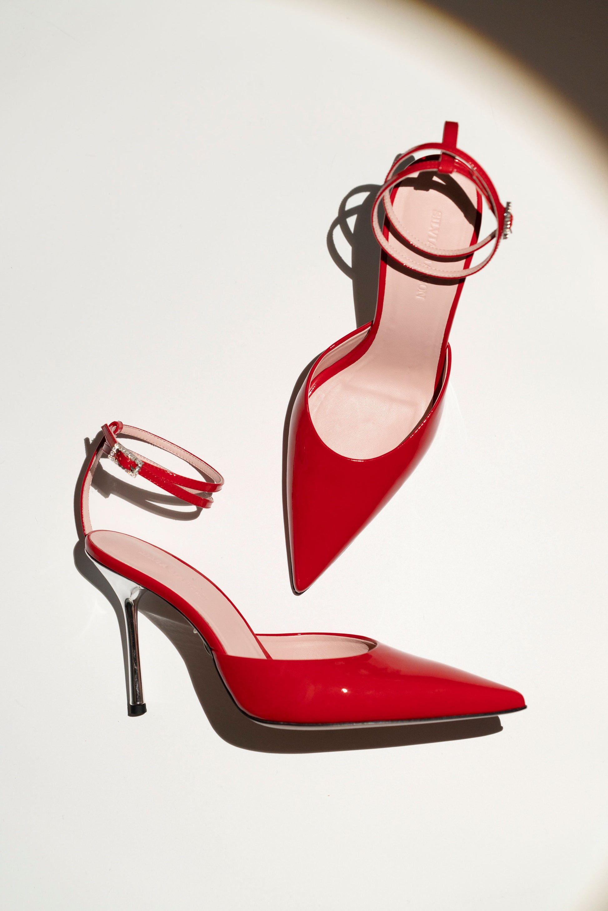 Lisandra Decollete Red Patent 95, still life, elegant red patent leather high heel by Silvia Marson