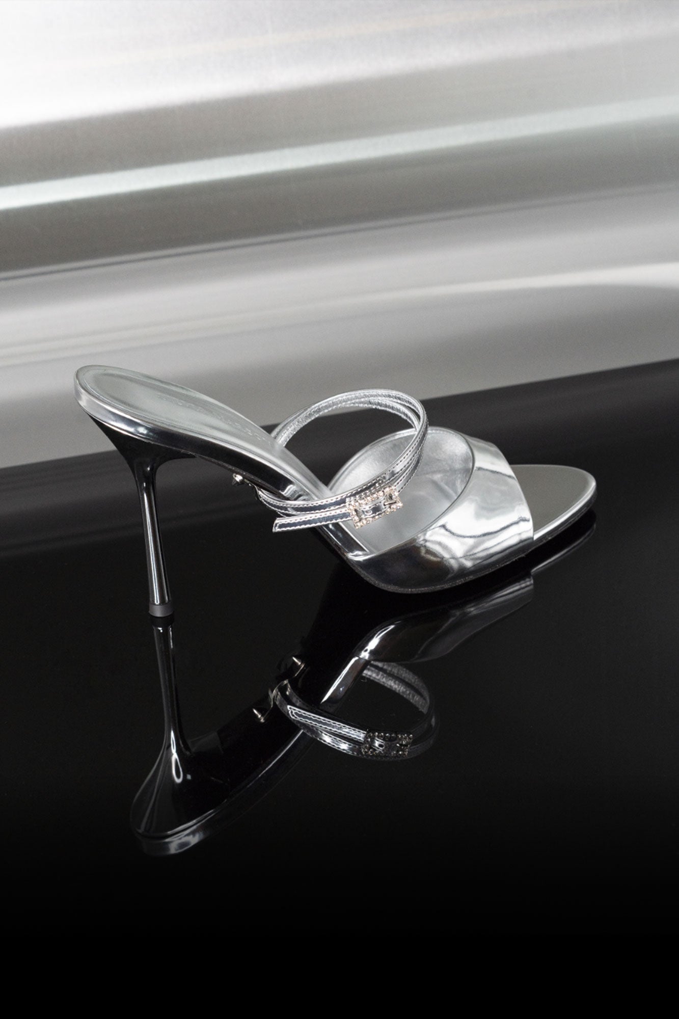 Close-up of Victoria Sandal Silver Mirror 95, high heel strappy sandals in silver mirror leather by Silvia Marson